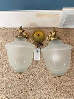 Both pendant lights with ceiling canopies visible side by side