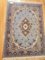 Full view of the rug showing overall design, colors, and fringe
