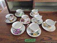 All eight tea cup and saucer sets displayed on tabletop