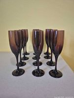 All 12 amethyst champagne flutes arranged on table