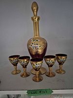 Full view of decanter with stopper and five matching glasses