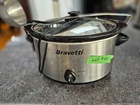 Bravetti slow cooker with glass lid and ladle on counter