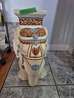 Front view of ceramic elephant garden stool showing glaze colors and overall form