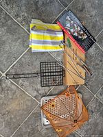 Full lot showing basket, tray, utensil box, kabob rack box, mesh cover, striped cloth
