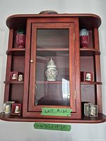 Full view of wall display cabinet showing dimensions label and contents