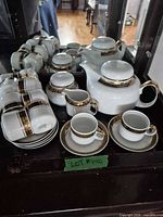 Group view of Chodziez porcelain tea set showing teapot, sugar bowl, creamer, cups and saucers