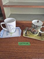 Overall view of both mug and saucer sets on wooden surface
