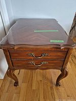 Full view of walnut nightstand showing drawers, legs, and overall form