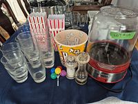 Full lot overview showing popcorn maker, glasses, popcorn tubs, grinders, picks