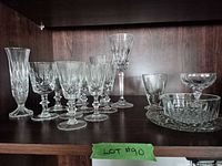Full group of stemware, bowl and plate on shelf