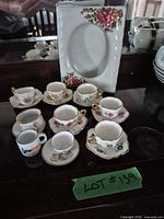 Group shot of ten-piece floral tea set including cups, saucers and serving plate