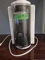 Front view of Hamilton Beach juicer showing clear smoke housing and power cord