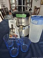 Juicer with pitcher, four glasses and manual displayed