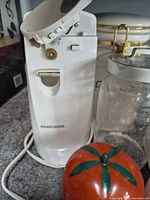 Black & Decker can opener, tomato container, glass jar, portion of ceramic canister