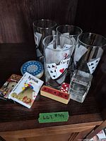 complete lot showing glasses, cards, dice, paperweight