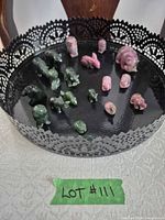 All 15 carved stone animals on black tray