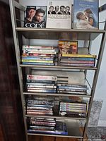 Full shelving unit holding entire lot of DVDs