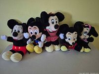 Group of five Disney plush toys