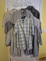 Group shot of eight plaid short-sleeve shirts on hangers