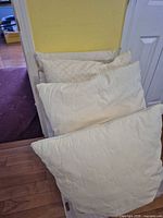 Four of the five pillows stacked showing color and pattern differences