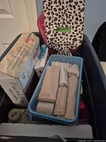 Overview of tote containing bandages, boxes, leopard bag
