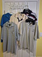 Six polo shirts hanging showing full fronts and colours