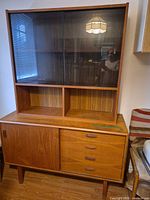 Full view of credenza with hutch showing glass doors, drawers, sliding door