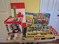 Group shot showing all five boxed games and bingo cage