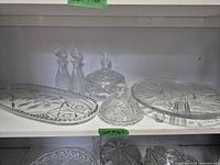 Overall view showing all cut and pressed glass serveware items on shelf