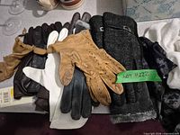 Assorted leather and knit gloves laid out showing colours and materials