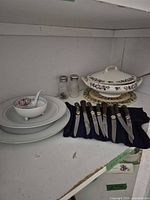 Overall view of dinnerware, steak knives, salt & pepper
