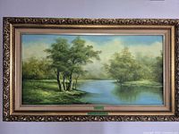 Frontal view of framed oil landscape painting