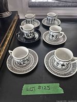Six cup-and-saucer pairs displayed