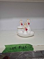 Set of three bone china pieces on shelf