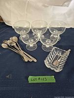 Group shot showing 5 sherbet cups, pressed dish and 6 long teaspoons