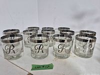 Group shot of 12 matching silver-rim rocks glasses
