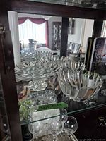 front view of three petal-edge bowls on shelf