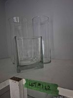 Three clear glass vases grouped together