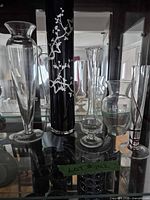 All five glass vases displayed together inside cabinet