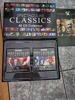 Closed box showing Spectacular Classics 40 CD Collection branding and open tray with two disc cases plus booklet