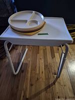 TV tray table with stacked plates on top