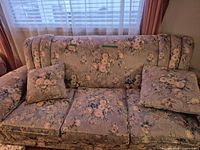 Front view of floral jacquard sofa with cushions