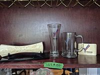 Full lot showing baton on stand, pilsner glass, beer mug, plaque card