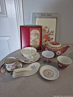 Entire lot arranged on countertop showing all porcelain pieces plus lacquered albums
