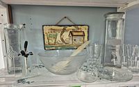 Full set on shelf showing all glassware, plaque and utensils
