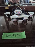 Full set showing teapot, four cups, saucer