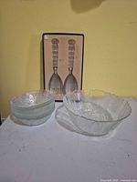 Group view: large bowl, stack of six smaller bowls, boxed salad servers