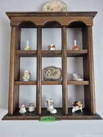 Full view of wall shelf and all porcelain figurines