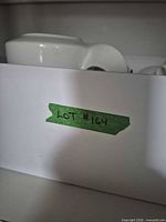 Shelf view showing lot identification tape and partial items