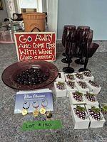 Overview of lot showing wine glasses, sign, bowl, napkin rings, wine charms, partial decanter
